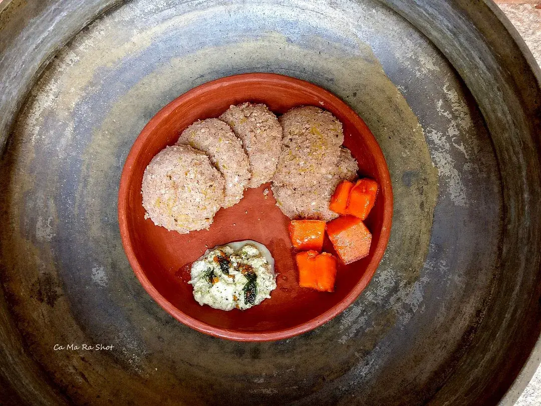 Idlis made from red rice rava and grated red pumpkin, served with coconut chutney