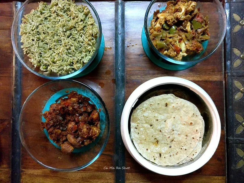 Gobi masala, baby potato masala, a green sabzi, and phulkas — the dinner spread